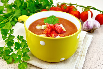 Image showing Soup tomato in yellow bowl on towel