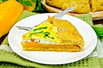 Image showing Pie of pumpkin and cheese in white plate on board