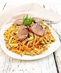 Image showing Salad of tongue and carrots with napkin on light board