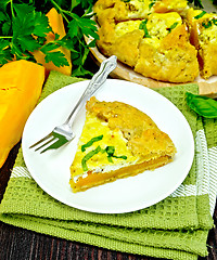 Image showing Pie of pumpkin and cheese in plate on dark board