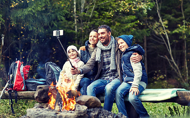 Image showing family with smartphone taking selfie near campfire