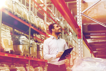 Image showing businessman with clipboard at warehouse