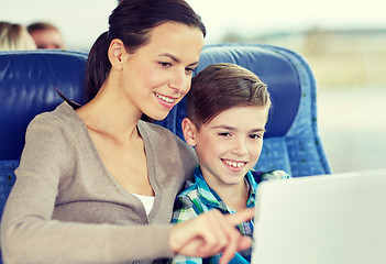 Image showing happy family with tablet pc sitting in travel bus