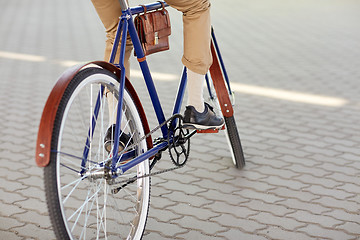 Image showing close up of hipster man riding fixed gear bike