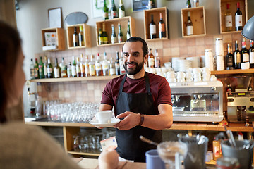 Image showing man or waiter serving customer at coffee shop