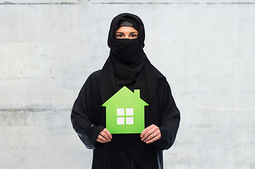 Image showing muslim woman in hijab with green house over white