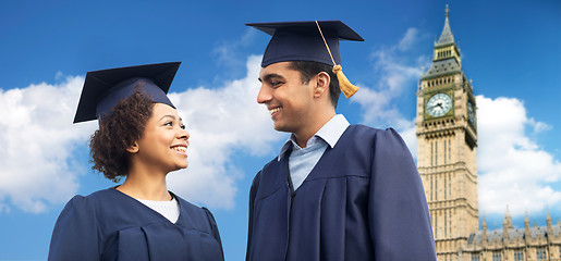 Image showing happy students or bachelors in mortar boards