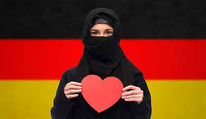 Image showing muslim woman in hijab holding red heart