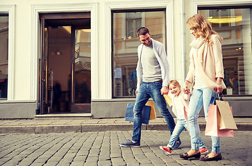 Image showing happy family with child and shopping bags in city