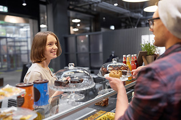 Image showing man or barman with cake serving customer at cafe