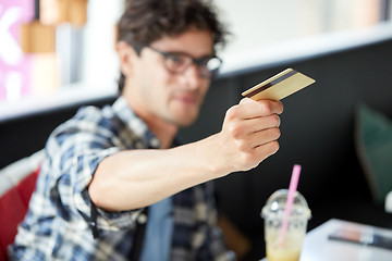 Image showing man paying with credit card at cafe
