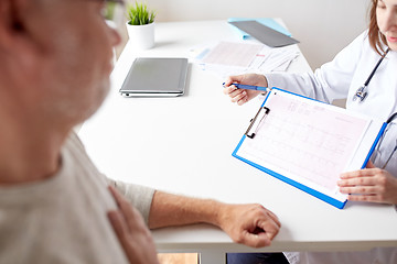 Image showing doctor showing cardiogram to old man at hospital