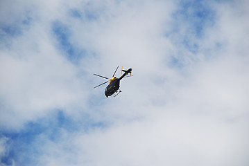 Image showing Police Helicopter in a Cloudy Blue Sky