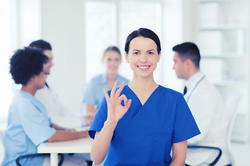 Image showing happy doctor over group of medics at hospital