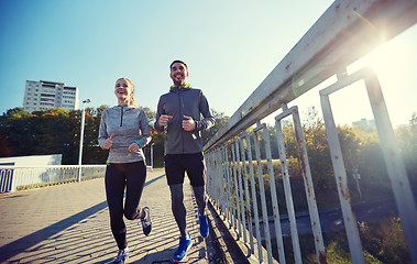 Image showing happy couple running outdoors