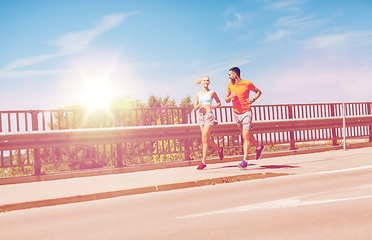 Image showing smiling couple running at summer seaside