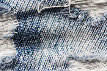 Image showing close up of holes on shabby denim or jeans clothes