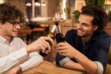 Image showing happy male friends drinking beer at bar or pub