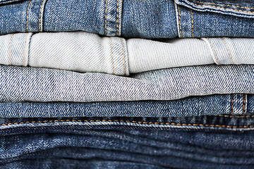 Image showing close up of denim clothes or jeans pile