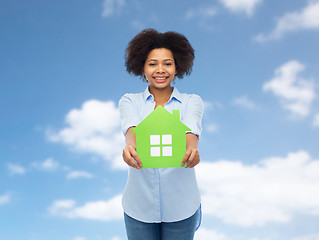 Image showing happy african american woman with green house icon