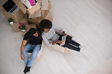 Image showing African American couple  playing with packing material