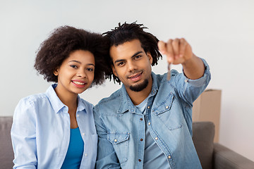 Image showing happy couple with key and boxes moving to new home