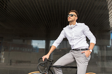 Image showing man with bicycle and headphones on city street