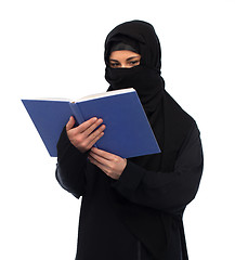 Image showing muslim woman in hijab reading book over white