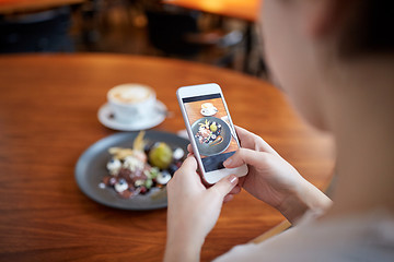 Image showing woman with smartphone photographing food at cafe