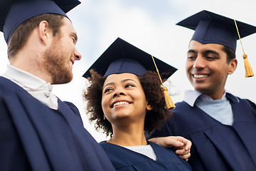 Image showing happy students or bachelors in mortar boards