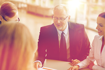 Image showing smiling business people meeting in office