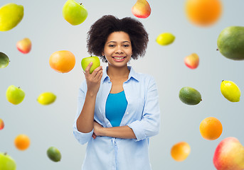 Image showing happy african american woman with green apple