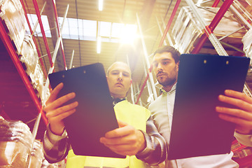 Image showing worker and businessmen with clipboard at warehouse