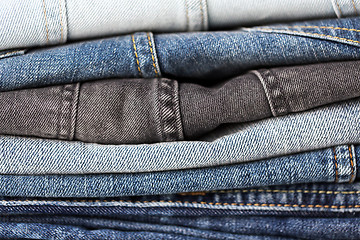 Image showing close up of denim clothes or jeans pile