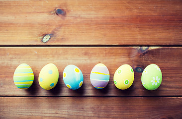 Image showing close up of colored easter eggs on wooden surface