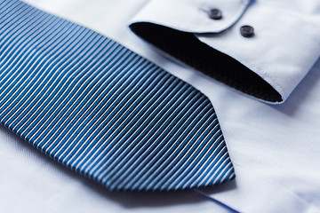 Image showing close up of shirt and blue patterned tie