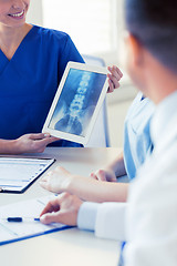 Image showing close up of happy doctors with x-ray at hospital