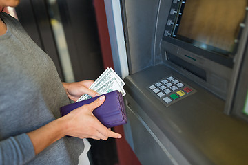 Image showing close up of hand withdrawing money at atm machine