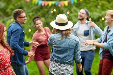 Image showing happy friends dancing at summer party in garden