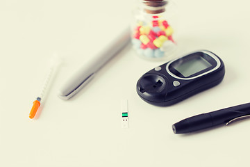 Image showing close up of blood sugar test stripe and glucometer