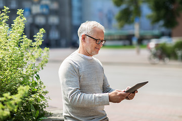 Image showing senior man with tablet pc on city street