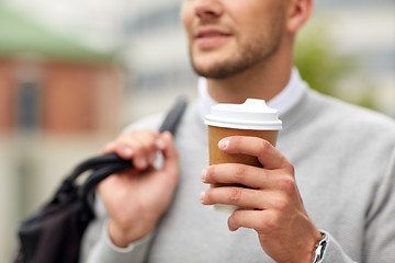 Image showing close up of man with coffee cup on street