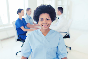 Image showing doctor or nurse over group of medics at hospital