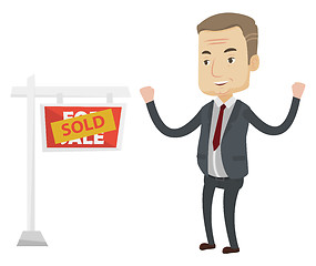 Image showing Agent standing near sold real estate sign.