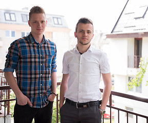 Image showing two young men standing at balcony