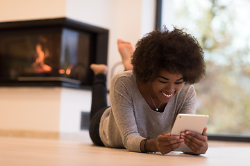 Image showing black women used tablet computer on the floor