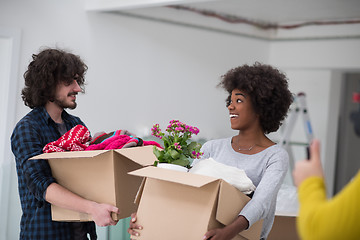 Image showing multiethnic couple moving into a new home