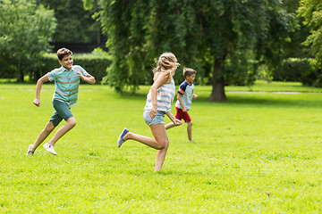 Image showing group of happy kids or friends playing outdoors