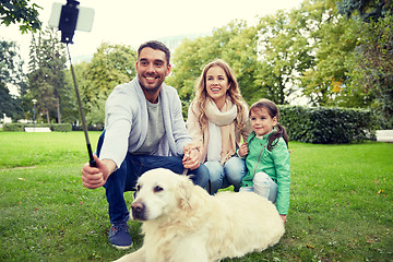 Image showing happy family with dog taking selfie by smartphone