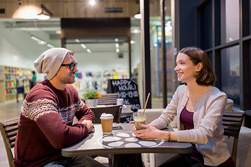 Image showing happy couple with coffee and smoothie at cafe